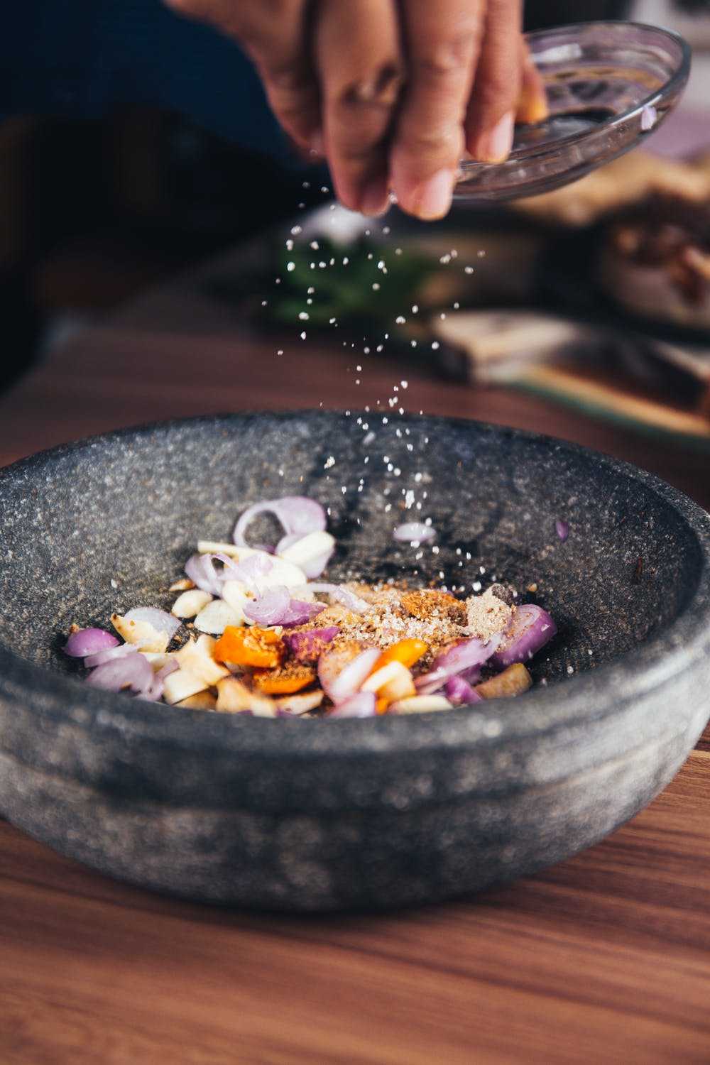 Person pouring salt in bowl